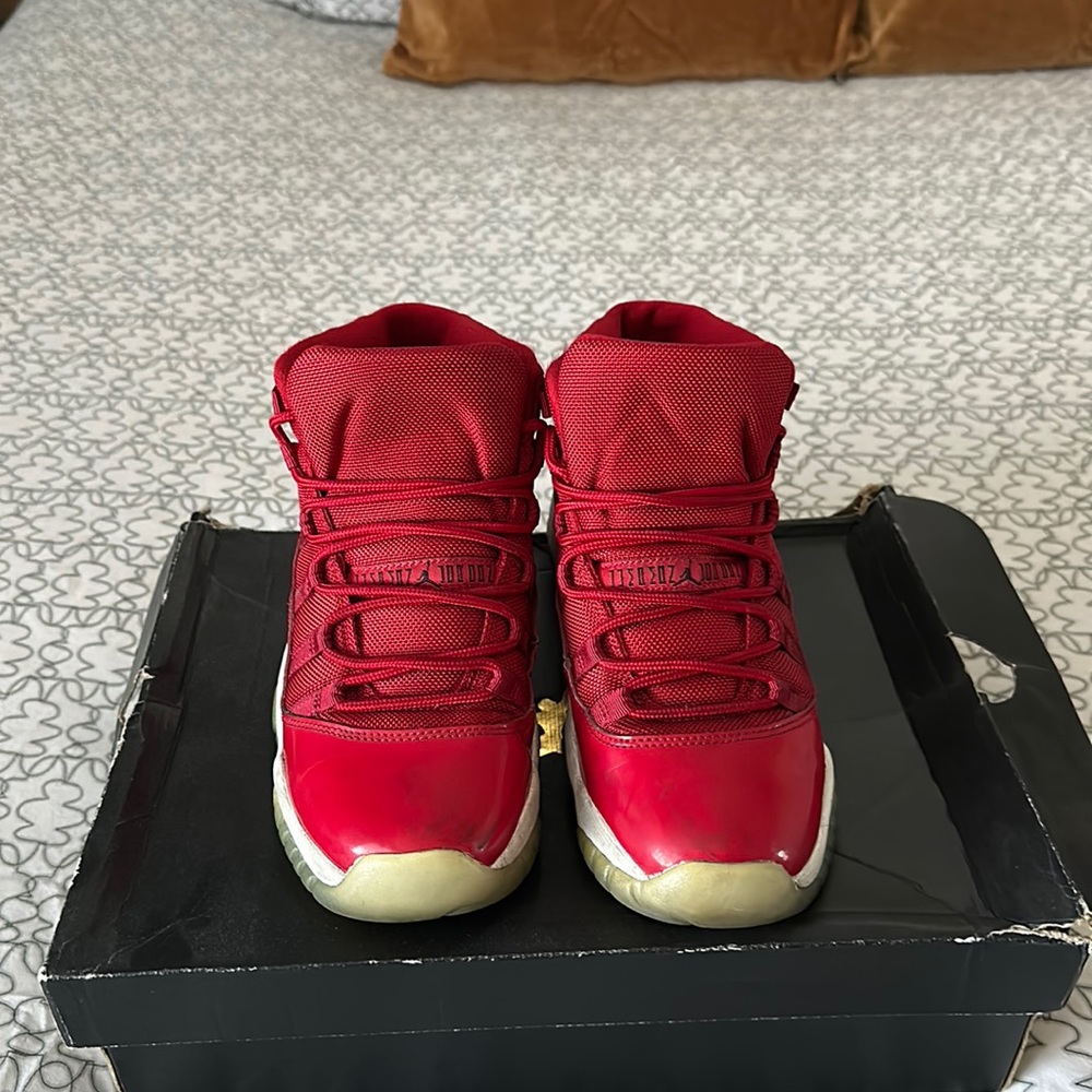 Selling these Jordan 11 red sneakers in fair condition.